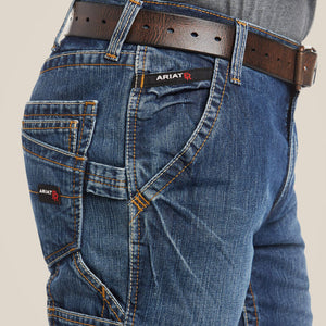 Side view close up of a man wearing Ariat FR M4 Boot Cut Jean