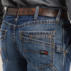 Close up of a man wearing Ariat FR M4 Boot Cut Jean showing back pocket