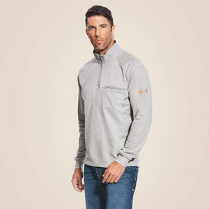 A man wearing ariat 1/4 zip FR pullover in grey color