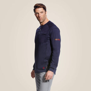 Sideview of a man wearing Blue Ariat FR Henley Shirt