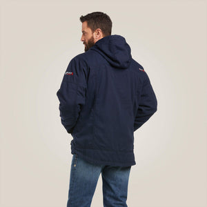 Back view of a man wearing blue Ariat stretch FR jacket
