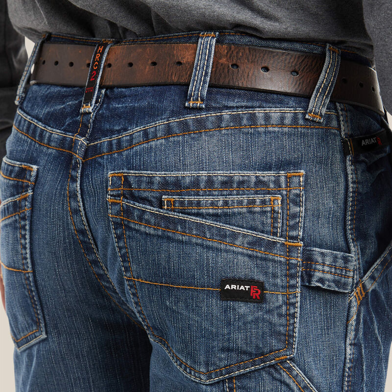 Close up of a man wearing Ariat FR M4 Boot Cut Jean showing back pocket